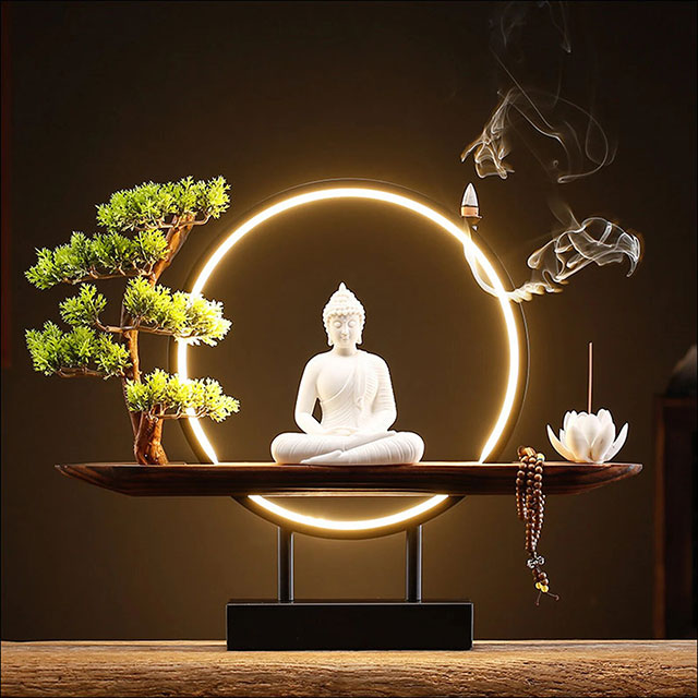 Buddha encircled with white light, lotus candle holder and bonsai on timber stand