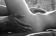 Hands caressing naked part of body