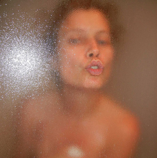 Woman kissing glass shower screen